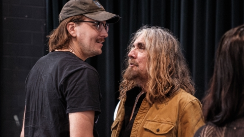 Thompson stands facing his father, Tom Wilson, during a rehearsal of the musical Beautiful Scars. 